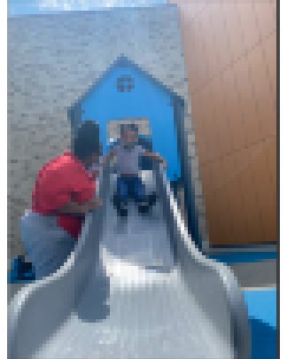 Teacher and child on slide